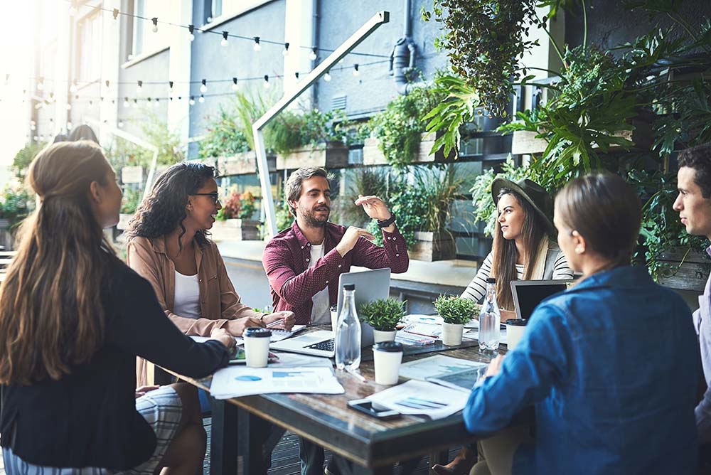A friendly group talking together around a café table